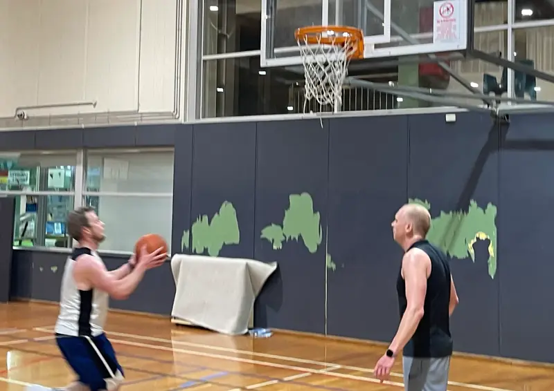 A Friday Hoops player rising for a jump shot at a relaxed social game
